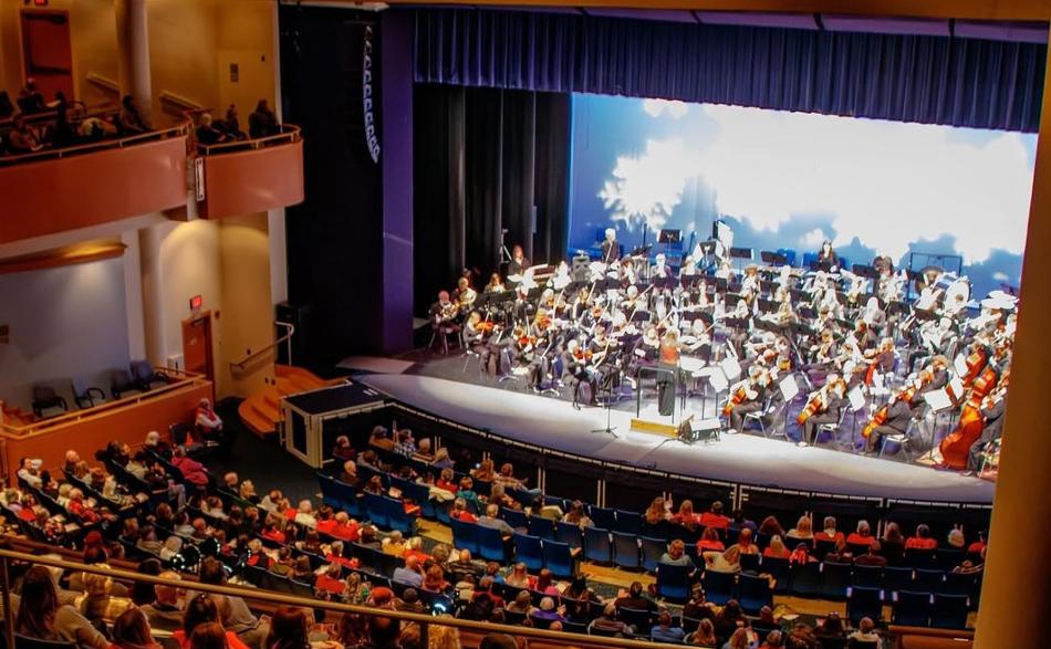 Symphony performing on stage from viewpoint of upper seating boxes